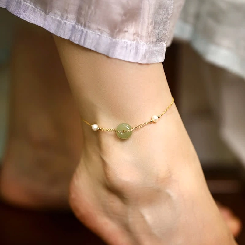 Hetian jade peace buckle pearl anklet worn on ankle with gold chain and white pearls