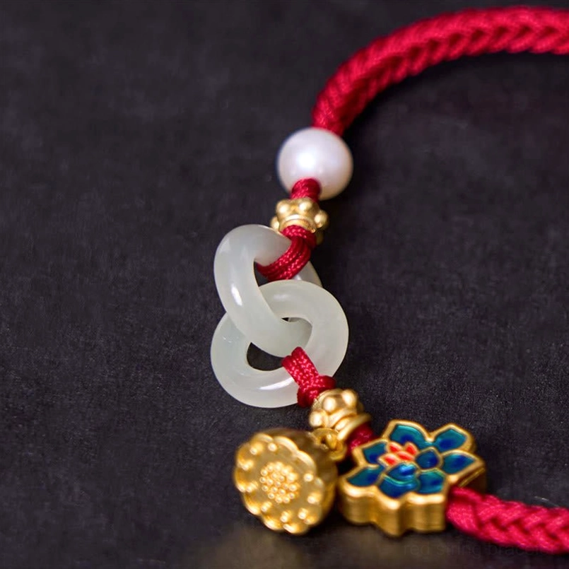 Close-up detail of Hetian jade peace buckle with enamel lotus charm and gold accents