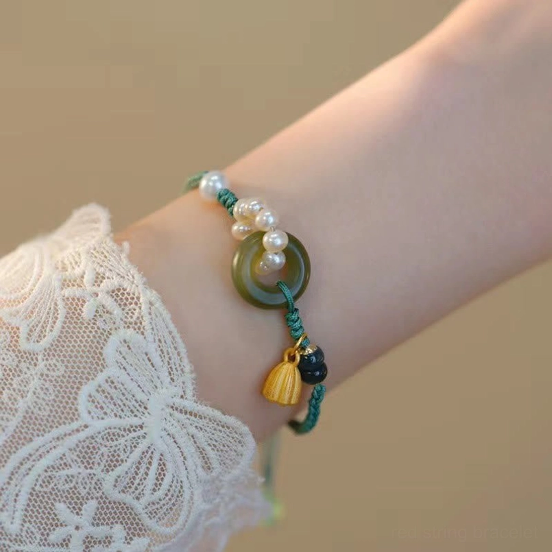 Natural hetian jade peace buckle bracelet worn on wrist over lace sleeve