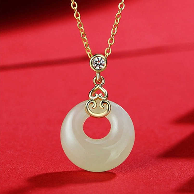 Hetian jade peace buckle necklace pendant with gold chain and zircon bail on red satin