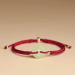 Hetian jade peace buckle red string bracelet side view with gold metal beads