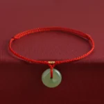 Hetian jade peace buckle red string bracelet front view with gold beads