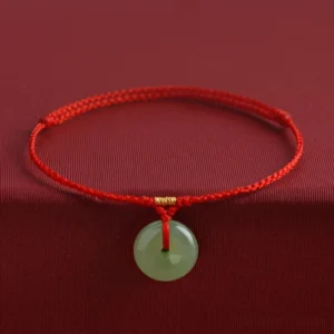 Hetian jade peace buckle red string bracelet front view with gold beads