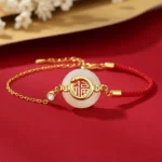 Hetian jade Fu peace buckle red string bracelet top flat lay on red floral background