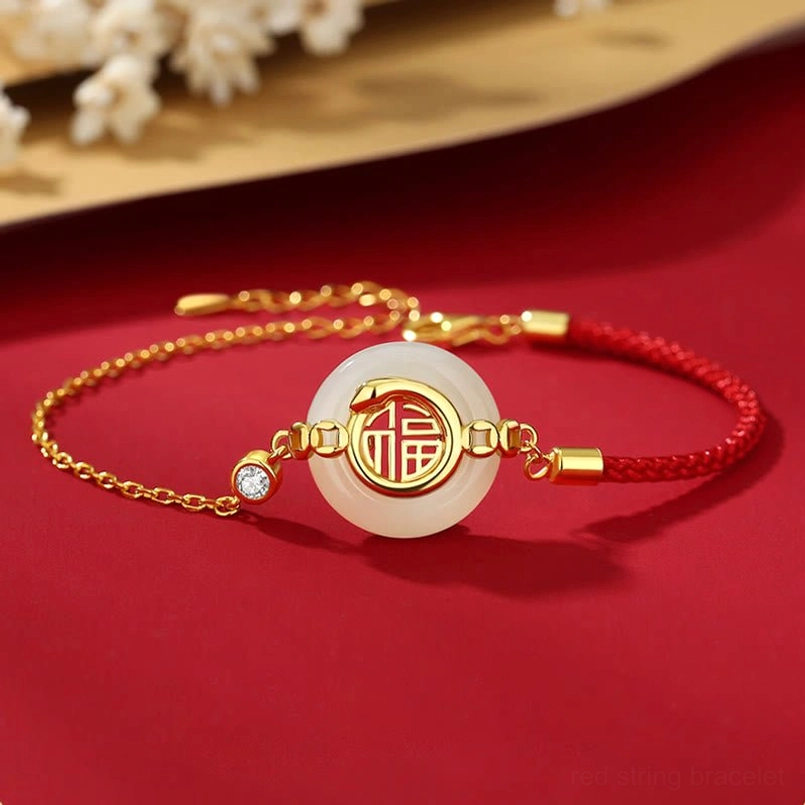 Hetian jade Fu peace buckle red string bracelet top flat lay on red floral background