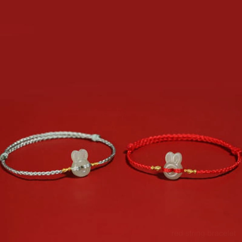 Two Hetian jade rabbit bracelets displayed together in gray and red rope colors