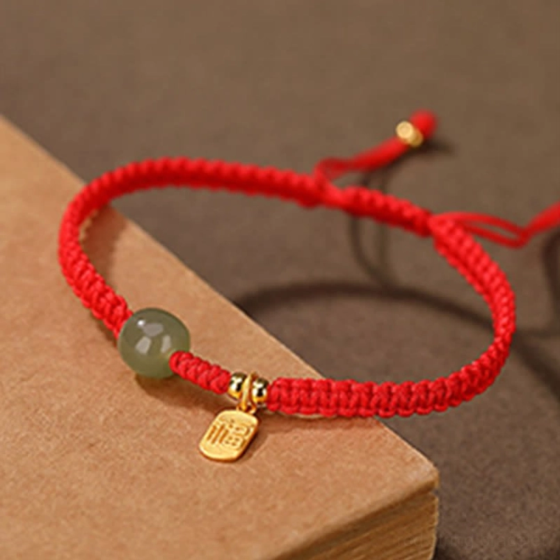 Hetian jade blessing bracelet red cord with centered bead and metal charm