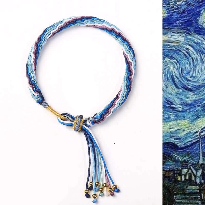 Premium hand-woven protective bracelet with blue-purple gradient weave and metal bead tassel detail