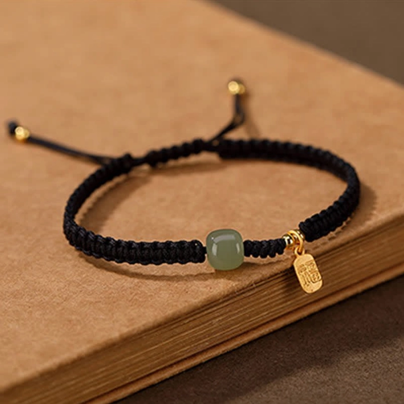 Hand-knitted Hetian jade red string bracelet showing traditional weaving technique detail