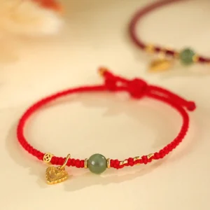 Hetian jade red string bracelet 925 silver heart copper coin charm closeup