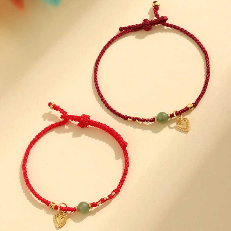 Two size variants of hetian jade red string luck bracelet flat lay
