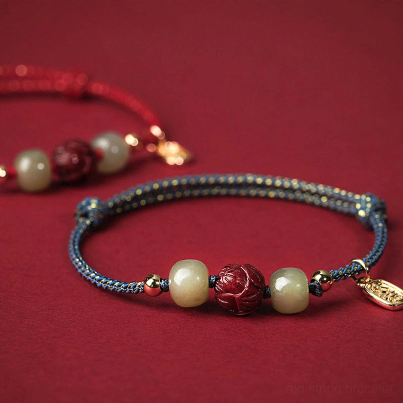 Two red string bracelets displayed from side view - jade and cinnabar bead details visible