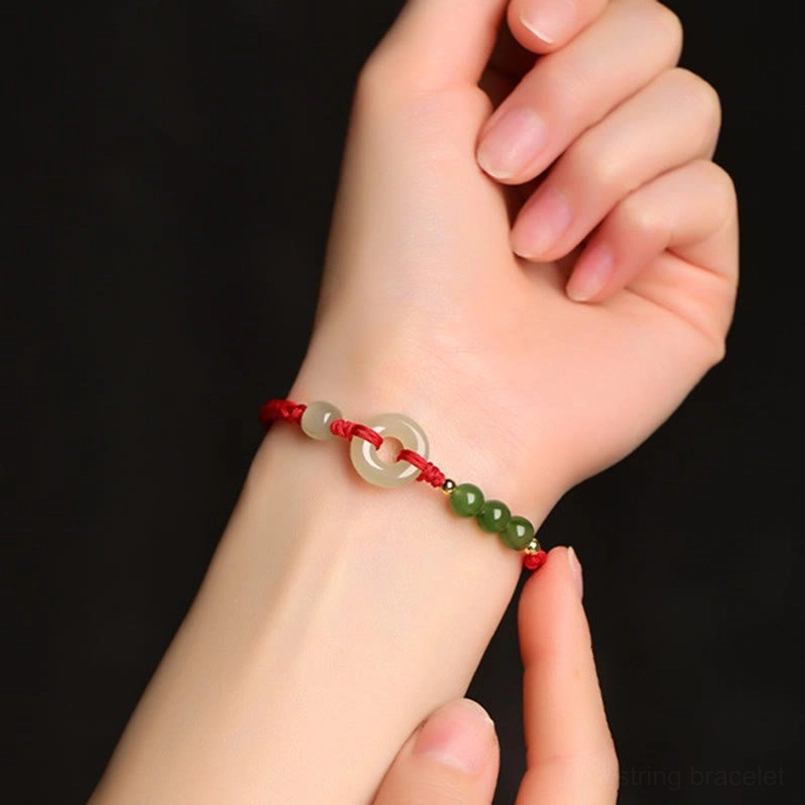 Hetian Jade Peace Buckle Red String Bracelet Worn On Wrist Close Up
