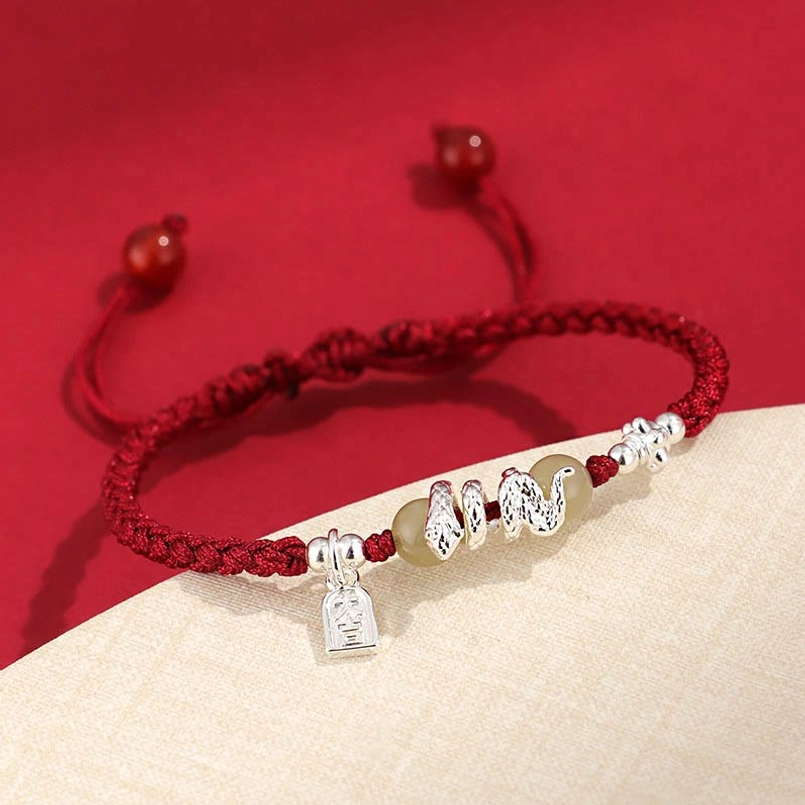 Snake year protection bracelet with braided red cord and silver snake charm detail