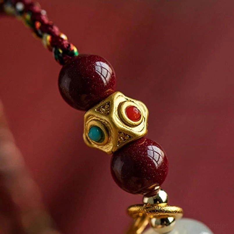 Hetian white jade prosperity bracelet with multi-colored string worn on wrist lifestyle shot