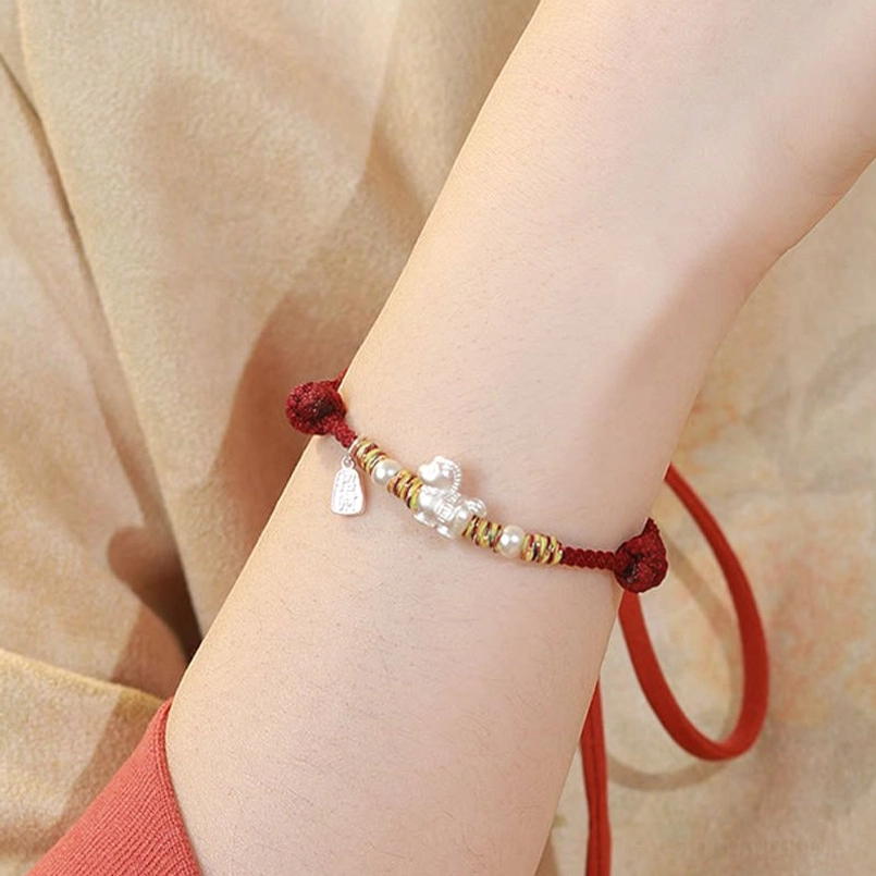 Adjustable red string horse bracelet slack cord detail close-up