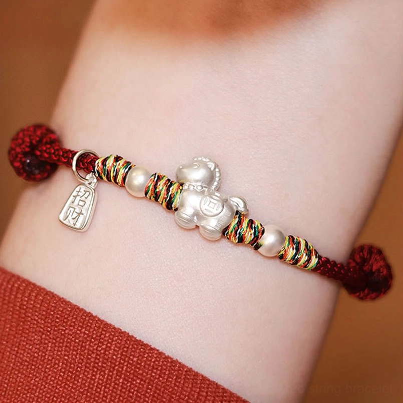 Worn horse silver red string bracelet on wrist close-up display