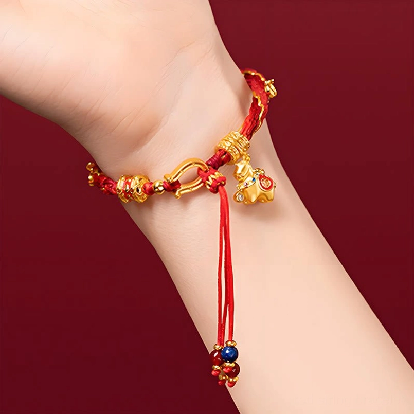 Red string luck bracelet with long beaded tassel, gold chain accents, and horse charm pendant worn on wrist