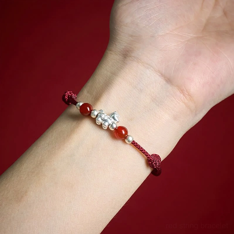 Wine red horse red agate bracelet close-up on wrist showing silver horse pendant