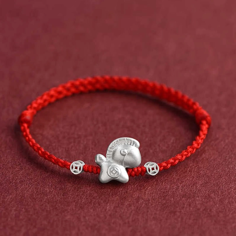 Front view of Year of the Horse red string bracelet displaying adjustable fit and silver ornament placement