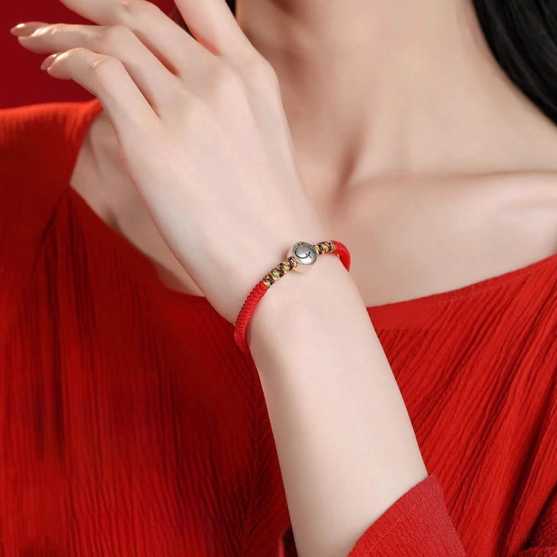 Zodiac Horse red string bracelet unboxing scene on neutral background