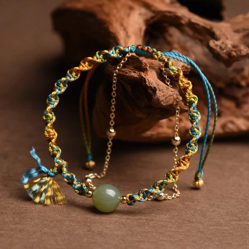 Handcrafted jade bead bracelet showing adjustable pull cords and metal chain detail