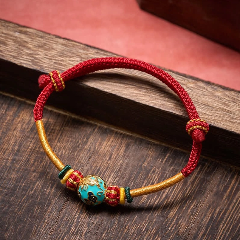 Jade dragon bead bracelet with adjustable sliding knots on dark wood background