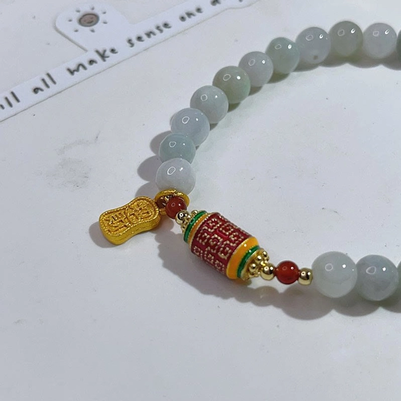 Close Up Of Smooth Natural Jade Beads And Gold Fu Pendant Bracelet