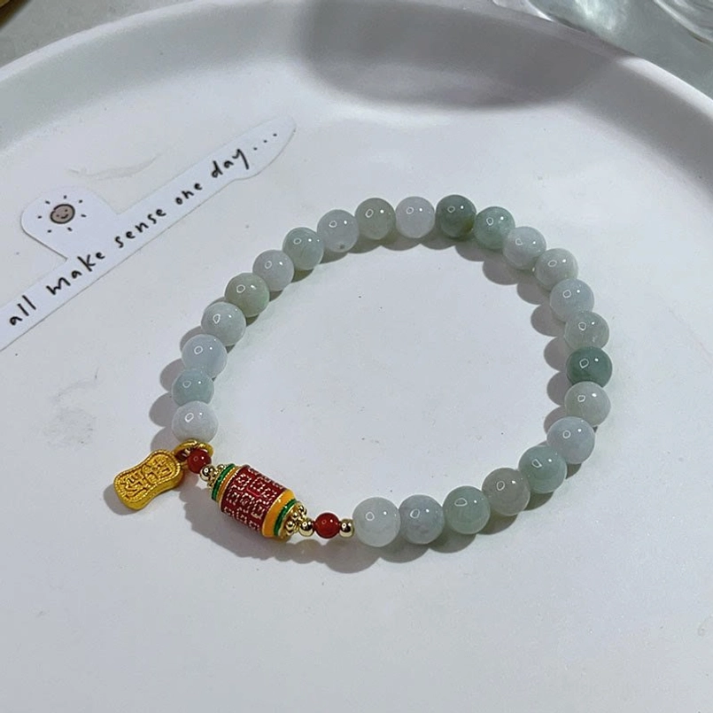 Gradient Jade Bead Fu Charm Red String Prosperity Bracelet On White Ceramic Tray