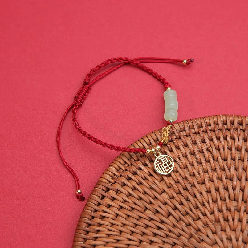 Light green jade beads with fu character gold pendant on adjustable red cord bracelet