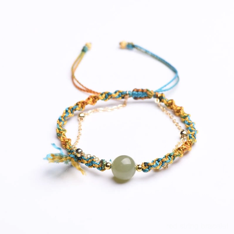 Jade luck bracelet with braided blue and gold rope showing adjustable pull ties