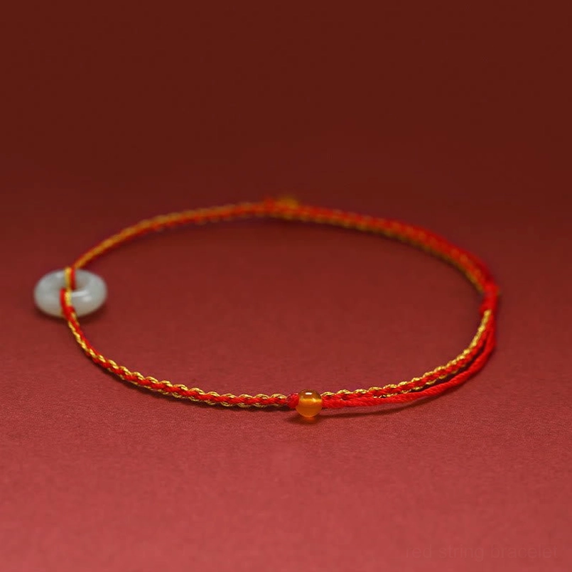 Side view of jade peace buckle bracelet showing braided cord texture and jade donut pendant detail