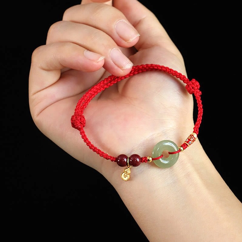 Hetian Jade Peace Buckle cinnabar bracelet worn on palm display