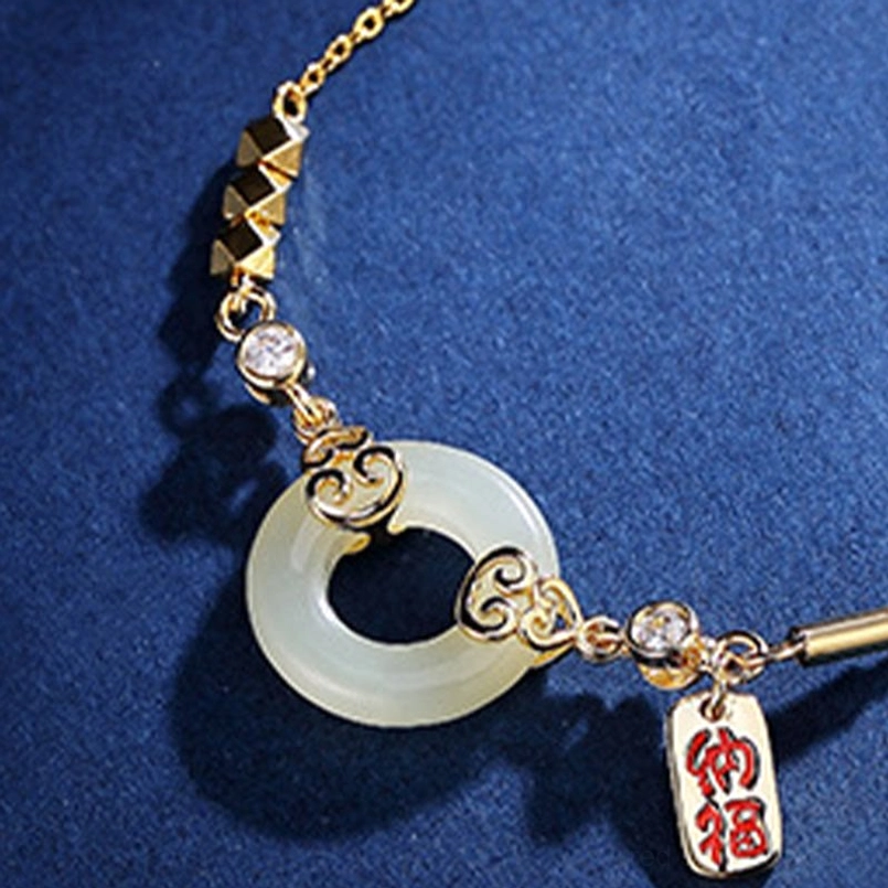 Hetian jade peace buckle bracelet close-up top view with zircon accents and fortune tag