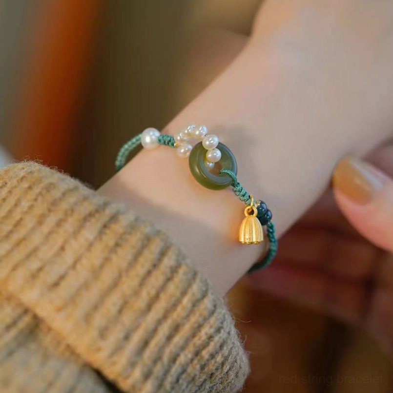 Side view of hetian jade peace buckle bracelet showing hanging lotus charm pendant