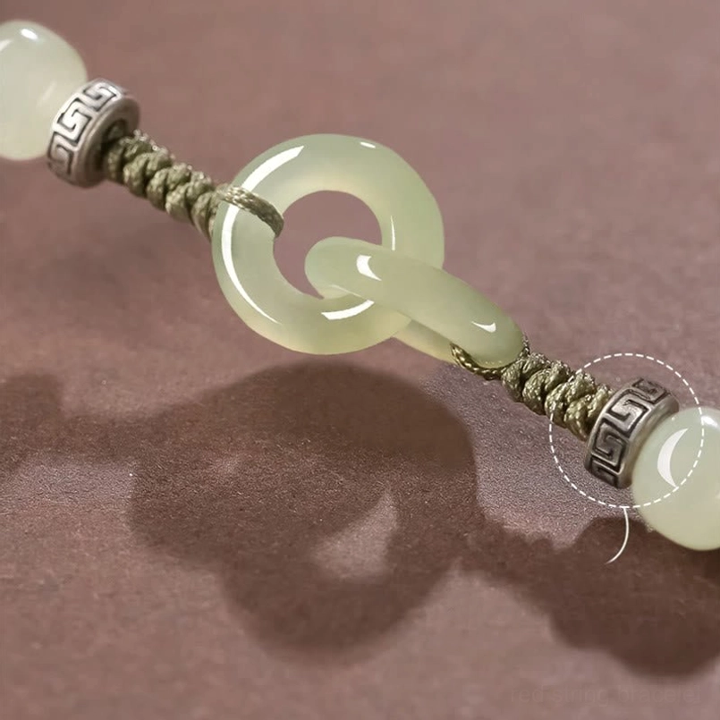 Macro view of interlocking jade peace buckles with metal accents and braided knot details