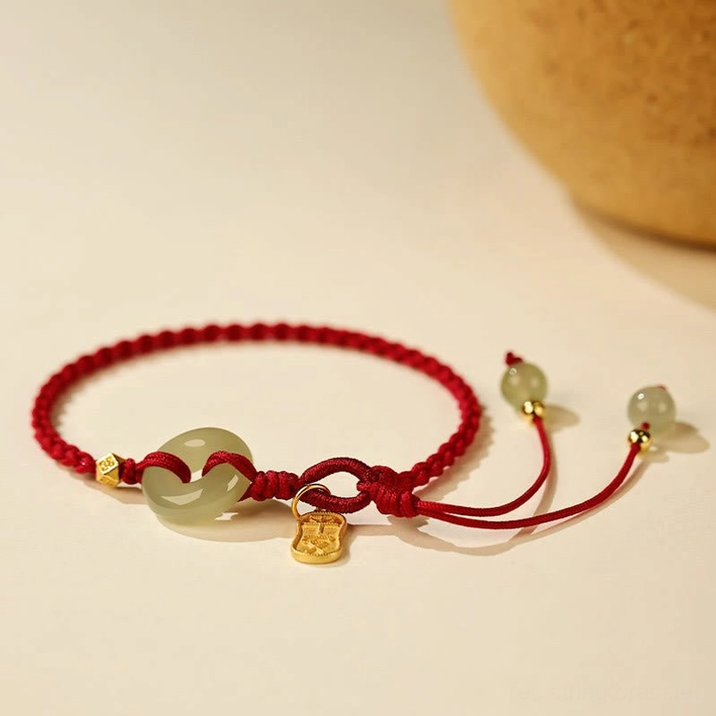 Jade peace buckle bracelet with woven red cord and gold accent beads front view