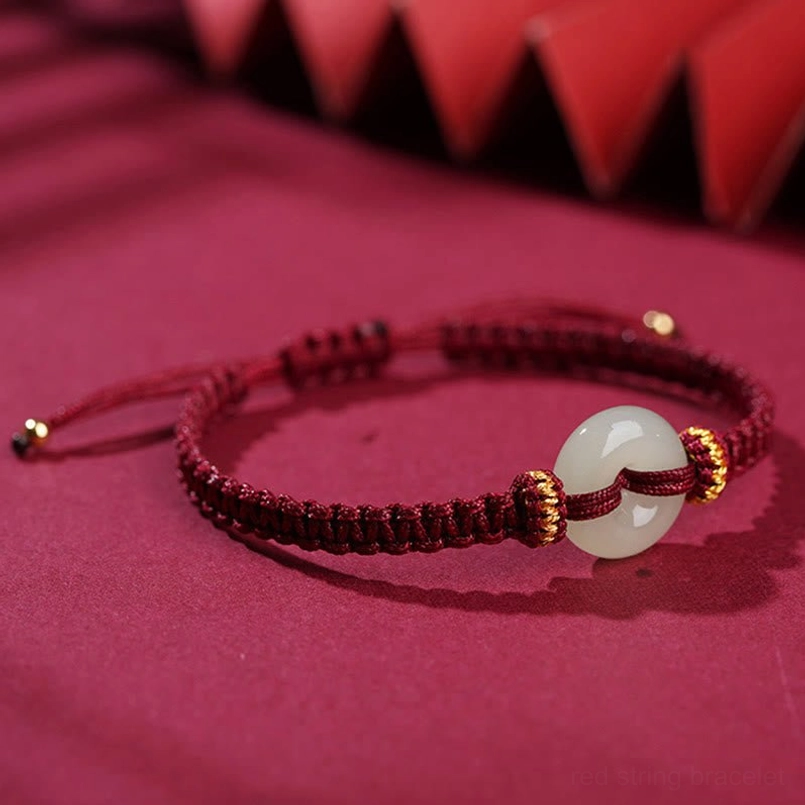 Red string bracelet with white jade peace buckle side view