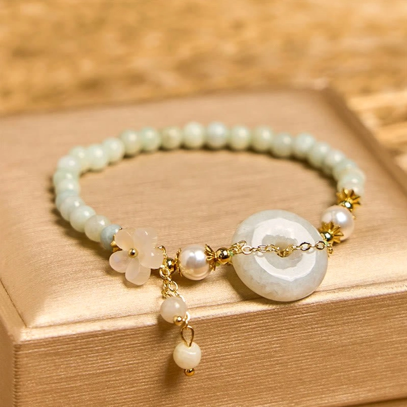Overhead view of jade peace buckle bracelet with matte gold accents and mixed light jade beads