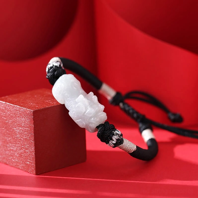 Adjustable Pixiu bracelet with natural jade charm - side angle showing braided string design