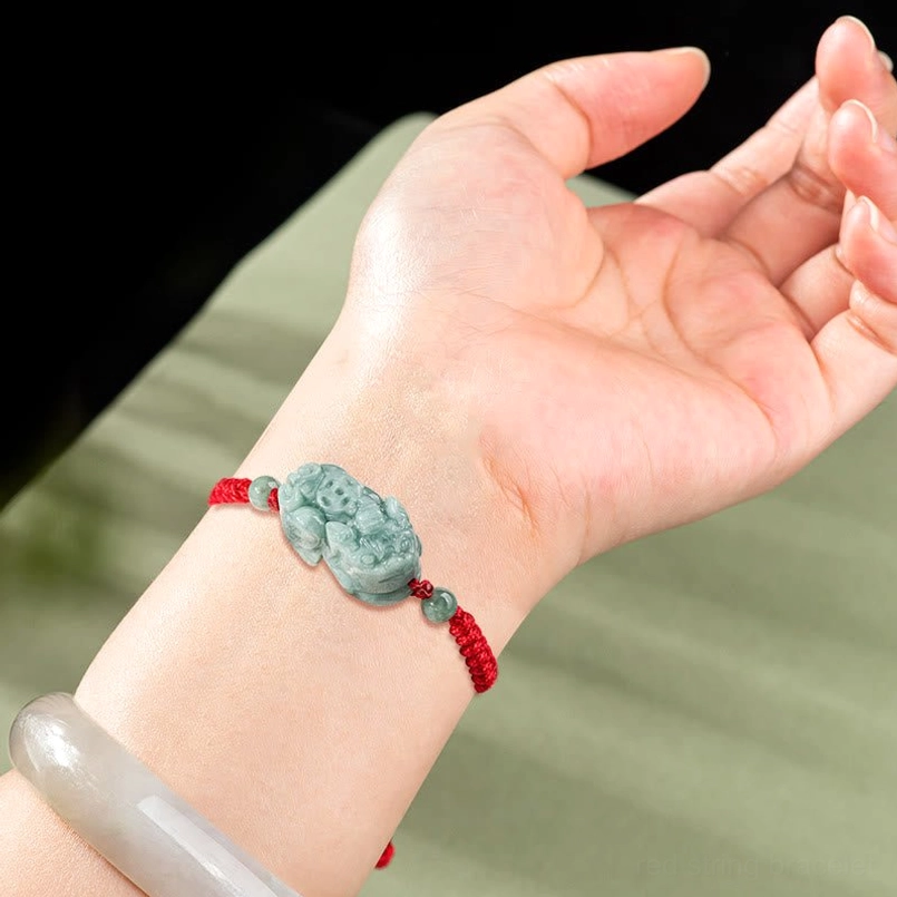 Red string Pixiu bracelet worn on wrist with matching jade bead companion