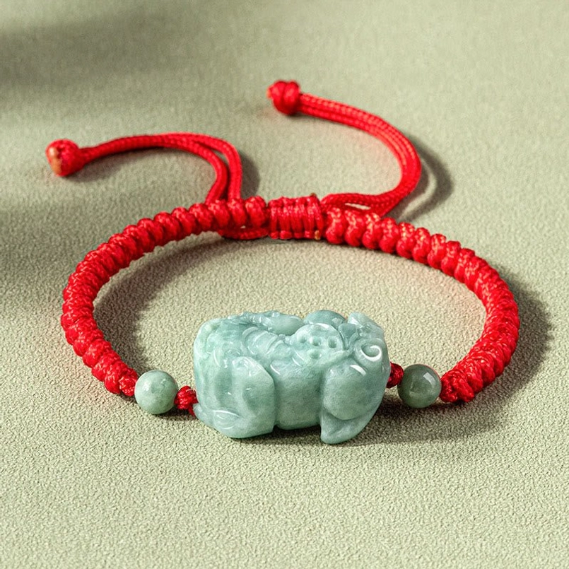 Handmade jade Pixiu red string bracelet with King Kong knot, flat lay view on gray background