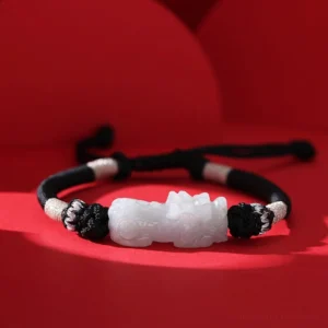 Handmade natural jade Pixiu wealth bracelet with braided red string - flat lay front view