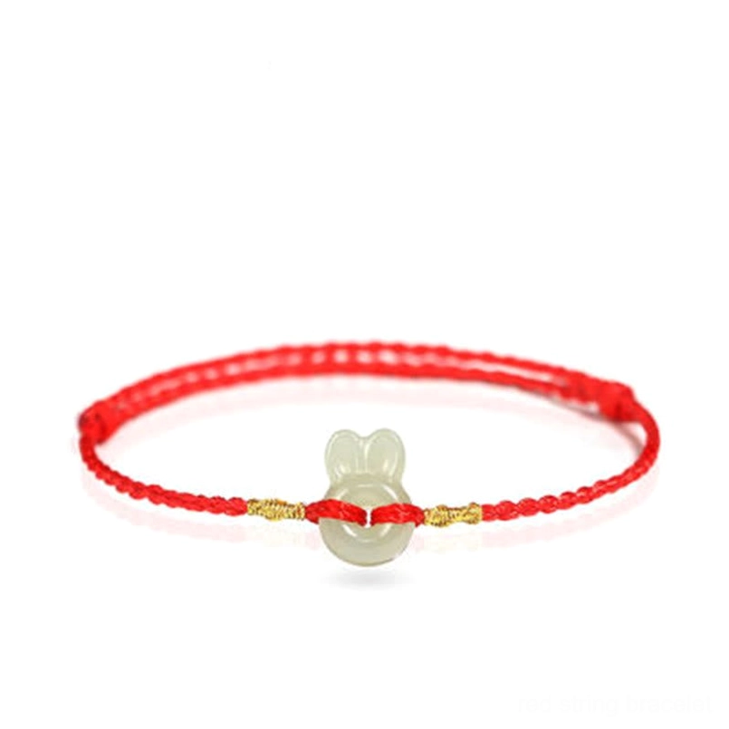 Hetian jade rabbit charm closeup on white background showing white jade bead detail