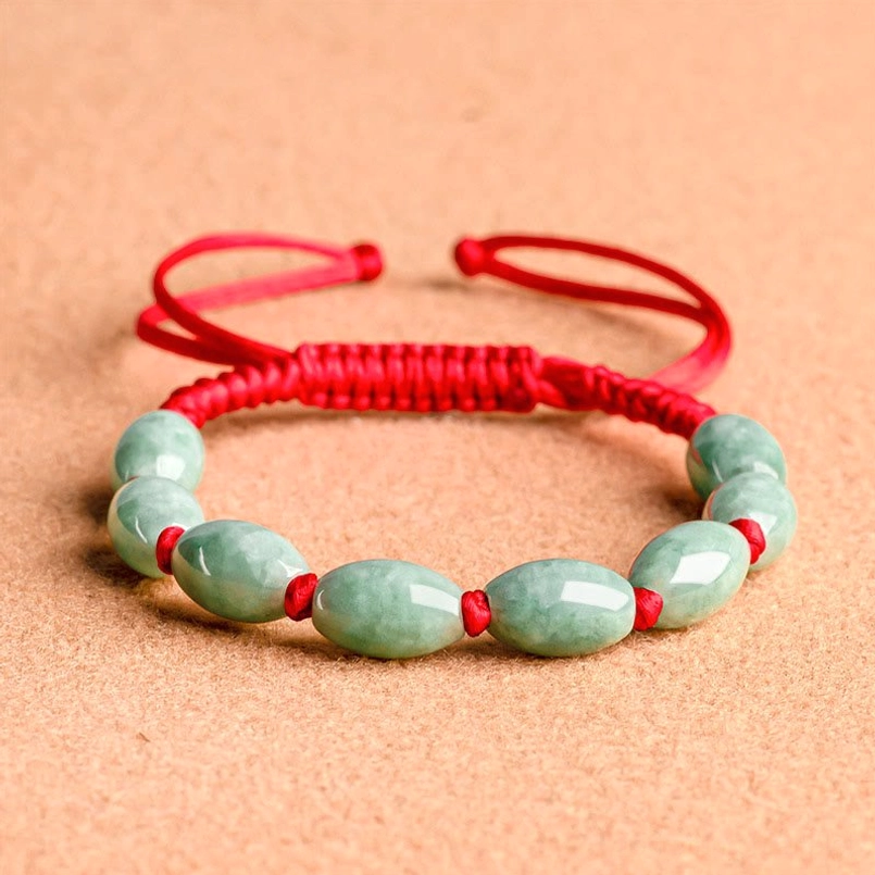 Jade red string bracelet side view showing adjustable slider knot