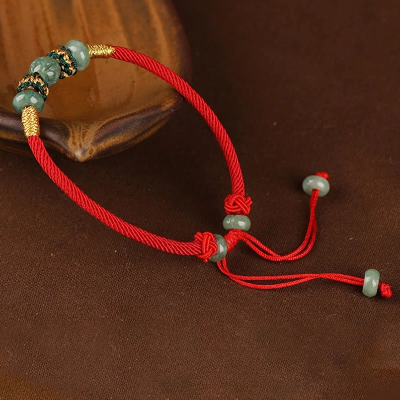 Jade red string bracelet adjustable pull tassel close up view
