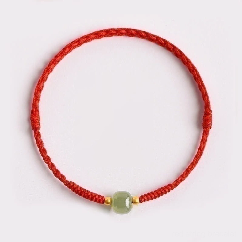Handmade jade prosperity bracelet with gold accent beads - centered detail view