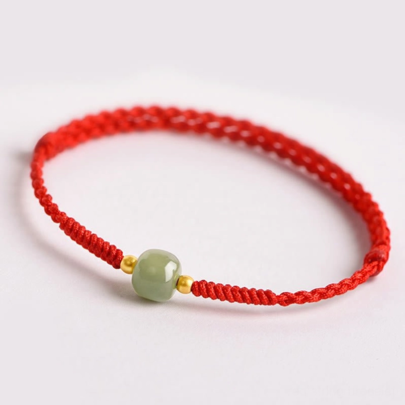 Premium jade and red string lucky bracelet - low angle circular view