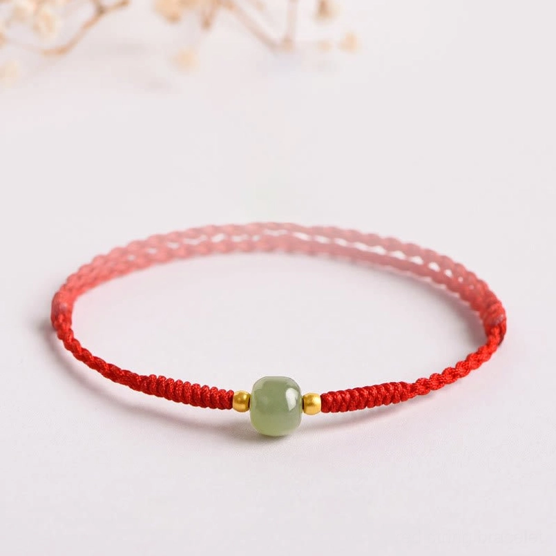 Handmade jade red string prosperity bracelet with gold spacers - three-quarter view