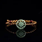 Jade sun braided string abundance bracelet main flat lay studio shot